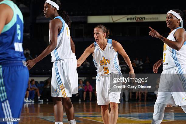 Michelle Snow, Erin Thorn, and Dominique Canty of the Chicago Sky get fired up after a great play made during the WNBA game against the New York...