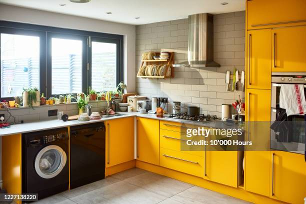 modern mustard yellow domestic kitchen - kitchen stock-fotos und bilder