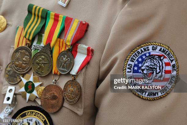 Medals on the chest of a Hmong war veteran forming an honor guard as they wait for the casket containing Hmong war hero and community leader General...