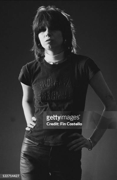 Chrissie Hynde, singer and guitarist with British rock band The Pretenders, poses for a studio portrait, against a black background, United Kingdom,...
