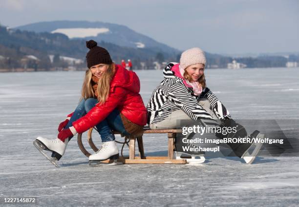 young happy girls ice skating at a lake, 14 years, irrsee, salzkammergut, upper austria, austria - upper austria stock pictures, royalty-free photos & images