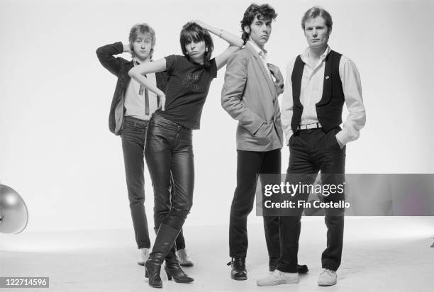 The Pretenders , British rock band, pose for a group studio portrait, against a white background, United Kingdom, in January 1979. Hynde leans...