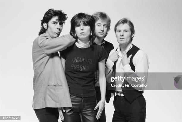 The Pretenders , British rock band, pose for a group studio portrait, against a white background, United Kingdom, in January 1979.