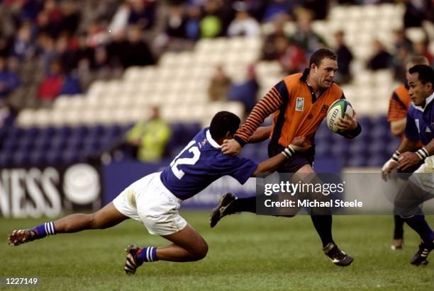 Jamie Mayer of Scotland hands off Terry Fanolua of Samoa during the Rugby World Cup quarter-final play-off match at Murrayfield in Edinburgh,...