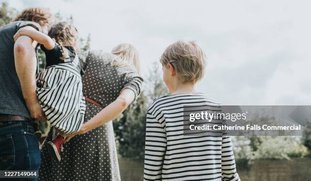 boy watching family - foster stock pictures, royalty-free photos & images