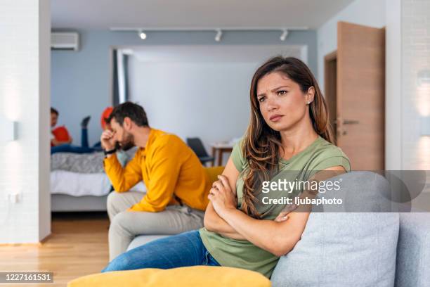 sad pensive woman thinking of relationships problems after fight - fighting stock pictures, royalty-free photos & images