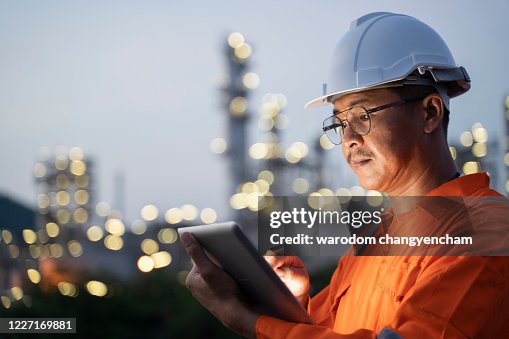 Engineer checks shipment of chemicals at oil and gas industry pipeline job site.