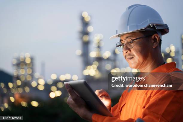 engineer checks shipment of chemicals at oil and gas industry pipeline job site. - power occupation stock pictures, royalty-free photos & images