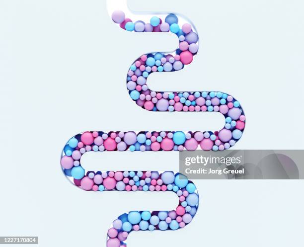 tube congested with multicolored spheres - colon stockfoto's en -beelden