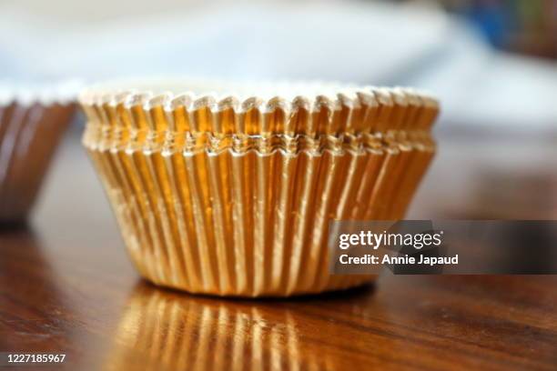 golden cupcake cakes on a table top in a home kitchen - cupcake holder stock pictures, royalty-free photos & images