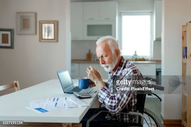 making sense of home finances - man in wheelchair stock pictures, royalty-free photos & images