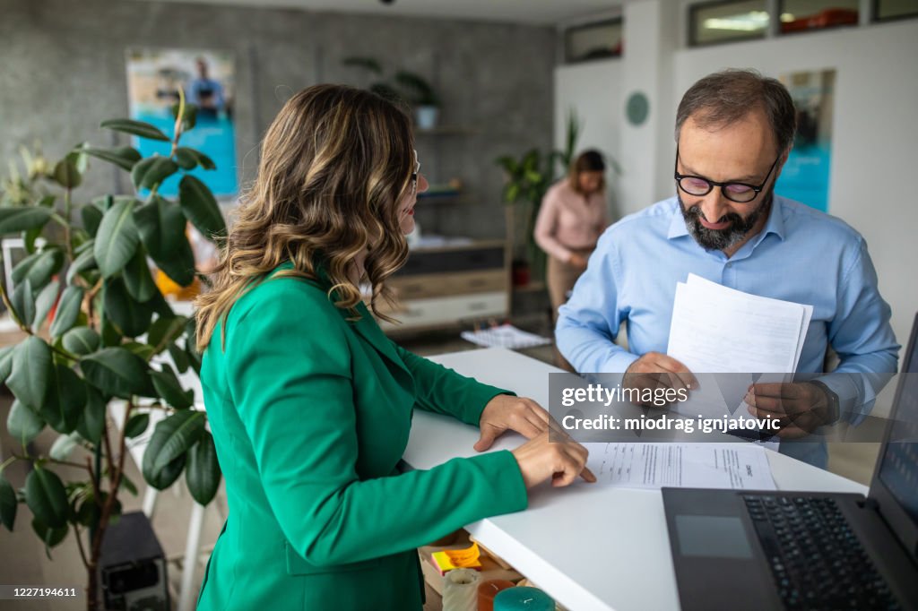 Businessman talking with financial advisor in bank