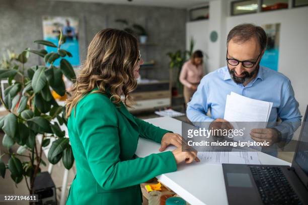 businessman talking with financial advisor in bank - banking stock pictures, royalty-free photos & images