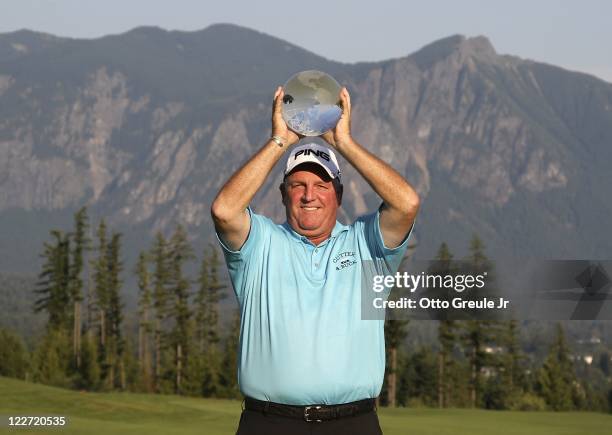 Mark Calcavecchia holds aloft the winners trophy after defeating Russ Cochran in a one hole playoff during the final round of the Boeing Classic at...