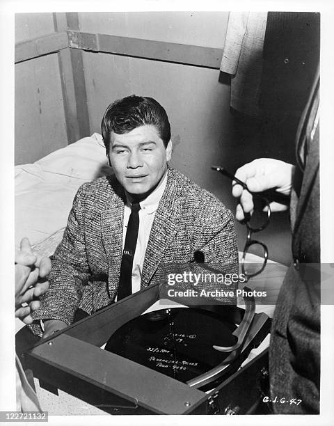 Ritchie Valens sits on bed in a scene from the film 'Go, Johnny, Go!', 1959.