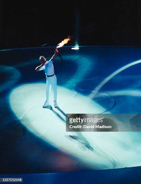 Paralympic archer Antonio Rebollo of Spain aims a flaming arrow to light the Olympic Cauldron during the Opening Ceremony of the XXV Olympiad on July...