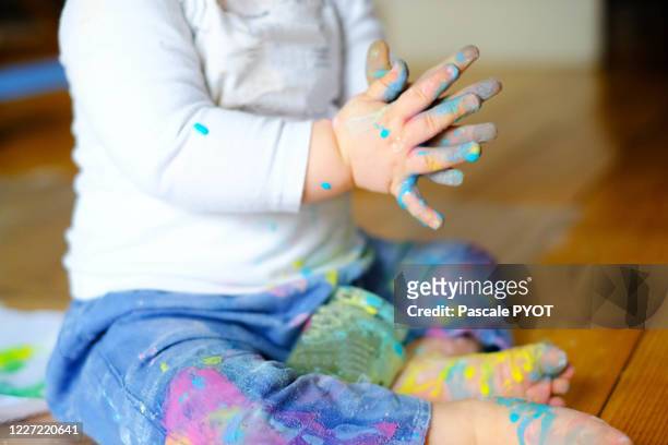 a baby is learning to paint - baby paint stock pictures, royalty-free photos & images