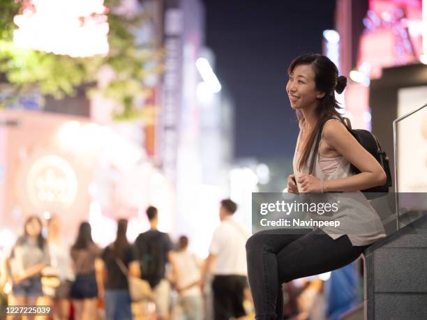 female asian tourist with backpack, in myeong dong street, seoul, korea - myeong dong fotografías e imágenes de stock