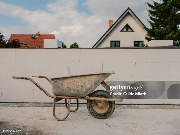 construction site with wheelbarrow. - carriola foto e immagini stock