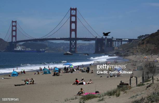 People sit on the beach at Baker Beach on May 26, 2020 in San Francisco, California. Beaches across the state have seen large crowds as they have...