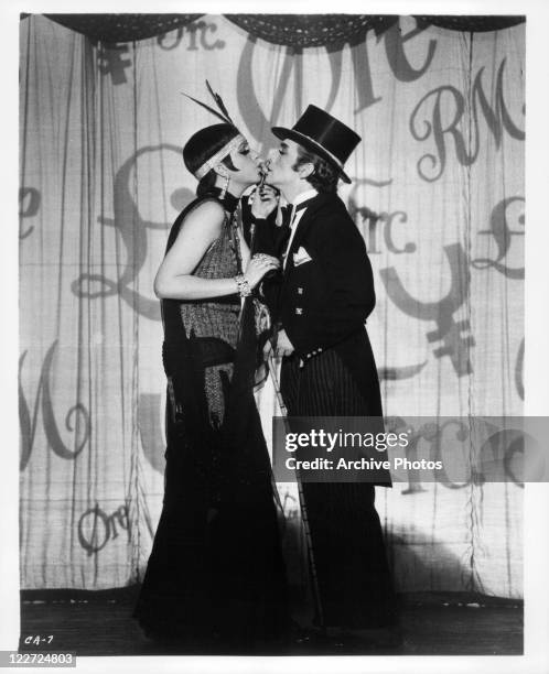 Liza Minnelli and Joel Grey about to kiss while performing on stage in a scene from the film 'Cabaret', 1972.