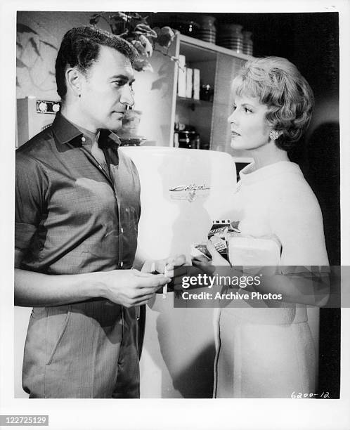 Peter Wyngarde and Janet Blair have discussion in the kitchen in a scene from the film 'Burn, Witch, Burn', 1962.