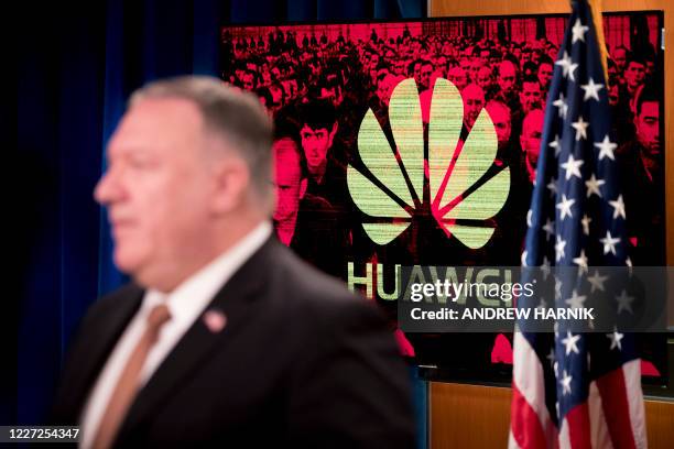 Monitor displays the logo for Huawei behind Secretary of State Mike Pompeo as he speaks during a news conference at the State Department in...