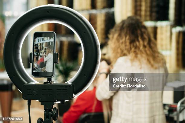 girl hairdresser doing hairstyle styling for a middle-aged woman in a beauty salon - backstage hairdresser stock pictures, royalty-free photos & images