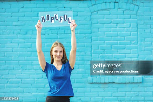 urban generation z female outdoors with handheld sign - hope word stock pictures, royalty-free photos & images