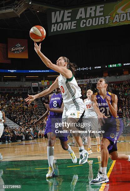 Sue Bird of the Seattle Storm goes to the basket against Ticha Penicheiro and DeLisha Milton-Jones of the Los Angeles Sparks during the game on...