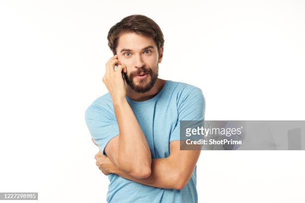cute man hugging himself and talking on the phone with a smile on a white background. - executive smile pointing bildbanksfoton och bilder