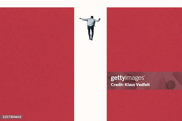 rear view of young man falling between red columns - nervous person clipart free stock pictures, royalty-free photos & images