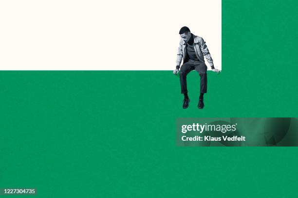 dejected man sitting on wall while looking down - waiting concept stock pictures, royalty-free photos & images