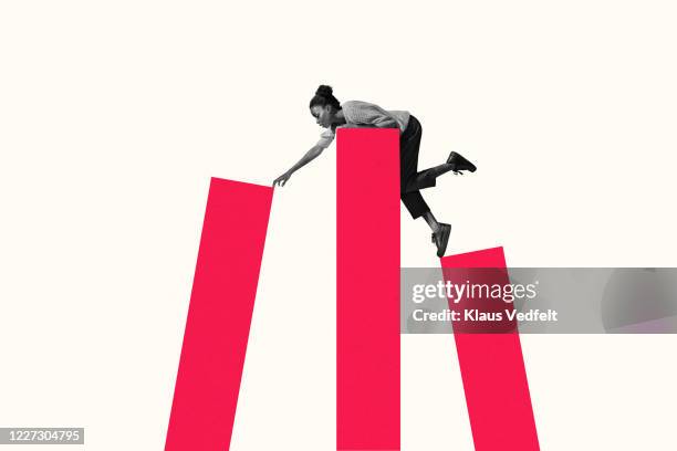 woman leaning on top while reaching for bar graph - resilienza foto e immagini stock