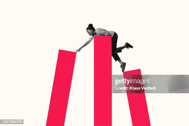 woman leaning on top while reaching for bar graph - risico stockfoto's en -beelden