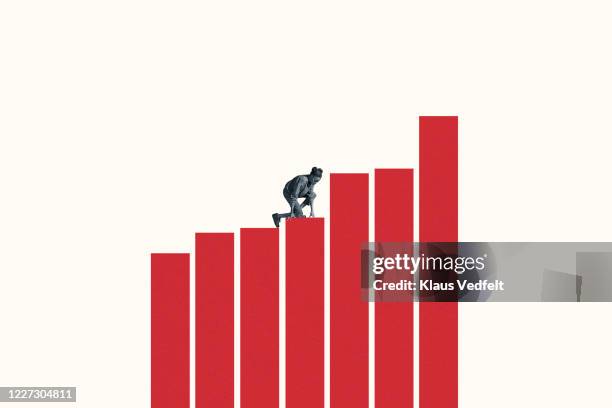 young woman climbing on large red bar graphs - karriereleiter stock-fotos und bilder