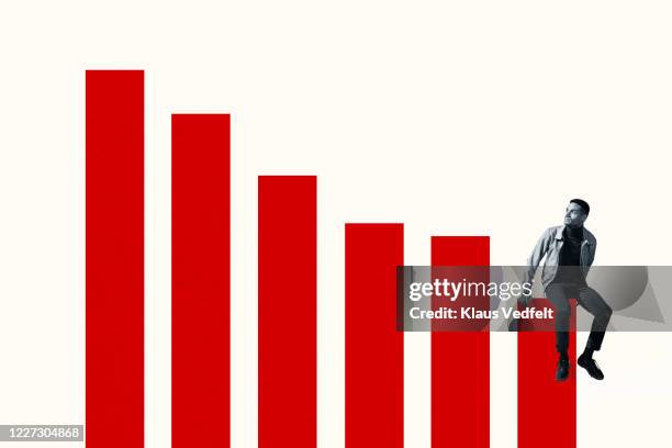 man sitting on bottom graph bar while looking up - think big stock pictures, royalty-free photos & images