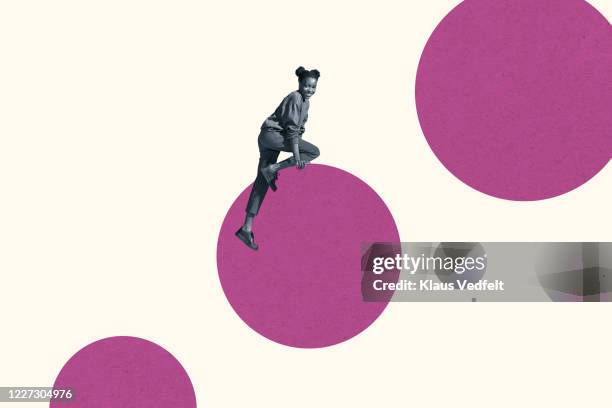 smiling young woman climbing on magenta circle - shapes and sizes stock-fotos und bilder