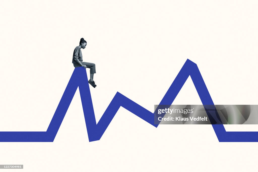 Side view of young woman sitting blue line graph