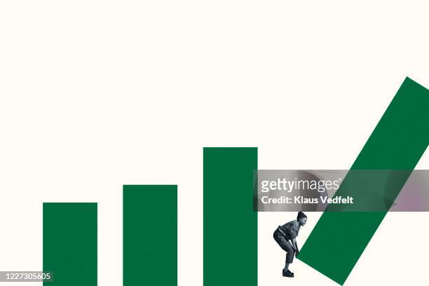 full length of woman arranging green bar graph - bias line stockfoto's en -beelden