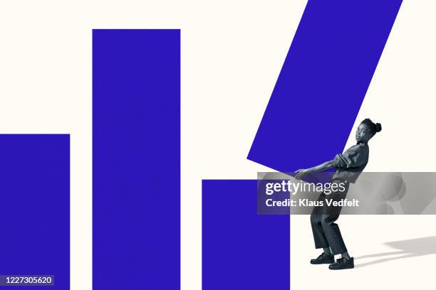 portrait of woman carrying large blue bar graph - initiation ceremony stock pictures, royalty-free photos & images