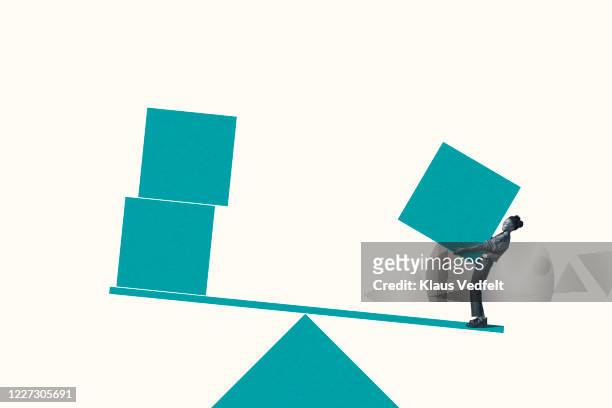 woman carrying turquoise block on weight scale - balance scale stock-fotos und bilder