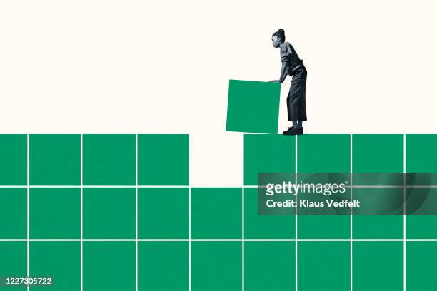 side view of woman building grid with green blocks - arrangement stock pictures, royalty-free photos & images