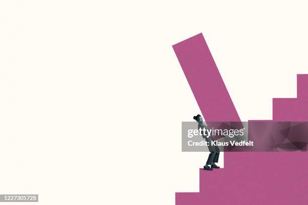 woman carrying large magenta bar graph on steps - portrait of young woman standing against steps stock pictures, royalty-free photos & images