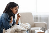 Risk Of Coronavirus. Sick Black Woman Coughing Hard At Home