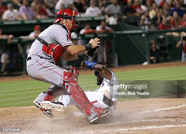 Jeff Mathis of the Los Angeles Angels of Anaheim make the catch to tag out Elvis Andrus of the Texas Rangers at Rangers Ballpark in Arlington on...