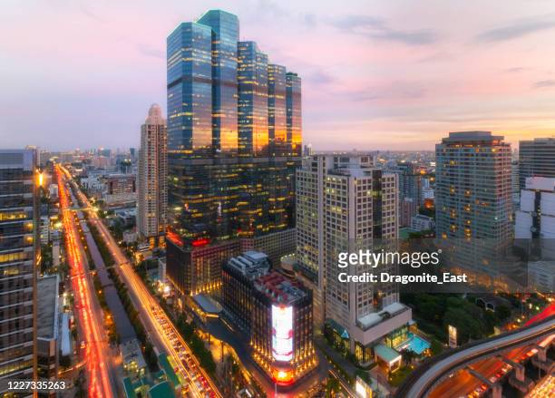view of sathorn district, bangkok downtown skyline, financial district and business in thailand with skyscraper and high-rise buildings at sunset. - bangkok business stock pictures, royalty-free photos & images