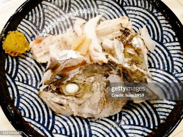 boiled sea bass (suzuki no arani), japanese traditional food - sudderen stockfoto's en -beelden