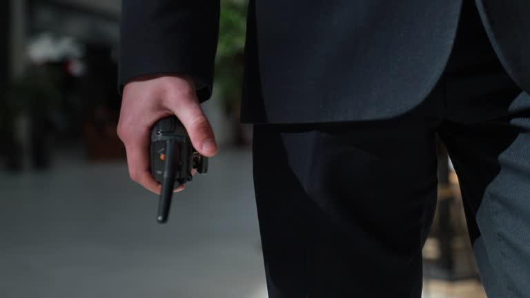 https://media.gettyimages.com/id/1227344723/video/the-guard-holds-a-walkie-talkie-in-his-hand-hand-of-a-security-guard-holding-an-intercom-in.jpg?b=1&s=640x640&k=20&c=tZhb_cnzdVCXT8jbEZonfYbwS9ur6vZBLXJWdP6YoYk=
