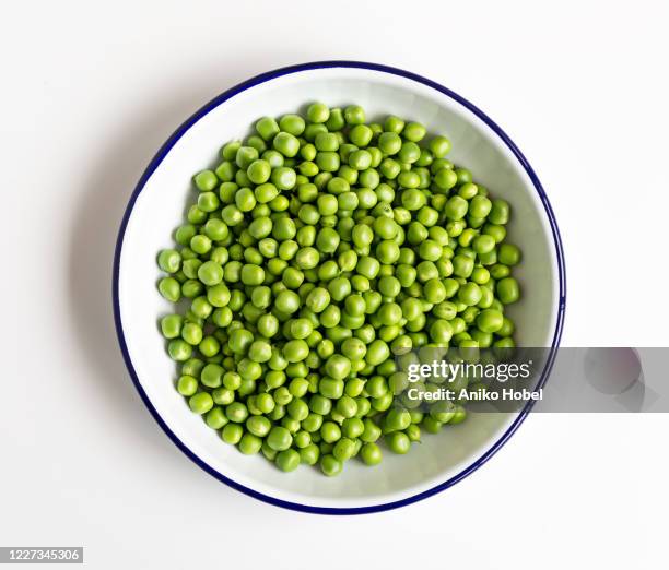 green peas on white background - green pea stock pictures, royalty-free photos & images